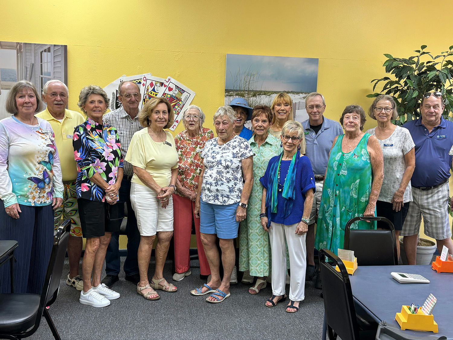 Members of a local bridge club gathered around a card table
